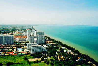 High angle view of cityscape by sea against sky