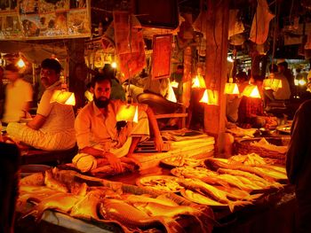 Portrait of vendor selling fish in market