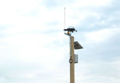 Low angle view of windmill against sky