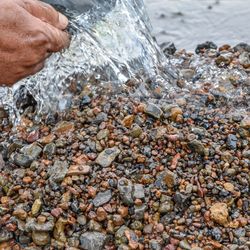 Cropped image of person holding ice cream at beach