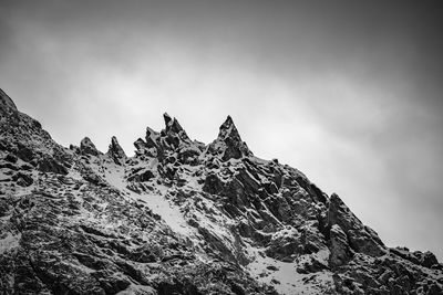 Low angle view of snowcapped mountain against sky