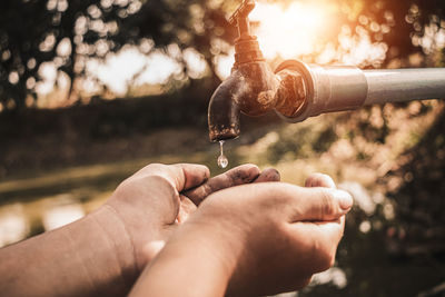 Close-up of hands holding water