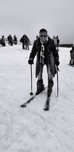 Full length portrait of man skiing on snow field during winter