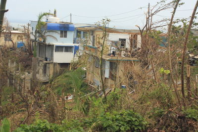 Abandoned buildings on field against sky