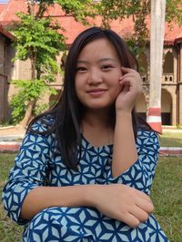 Portrait of a beautiful young woman sitting outdoors