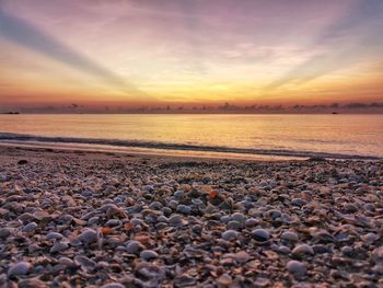 Scenic view of beach against sky during sunset