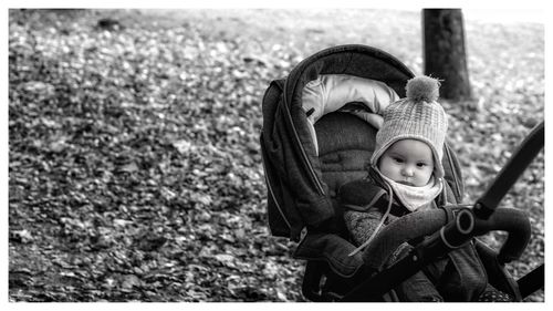 Cute baby girl with toy on land