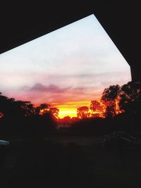 Silhouette trees against sky during sunset