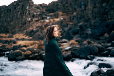 Woman standing on rock in snow