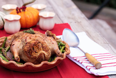 Close-up of roast chicken in container on table