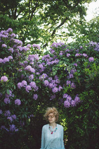 Woman against purple flowering plants