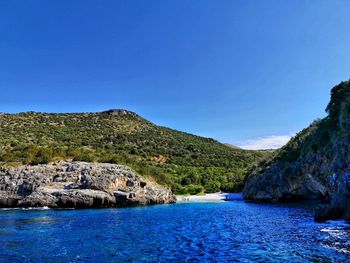 Scenic view of sea against clear blue sky