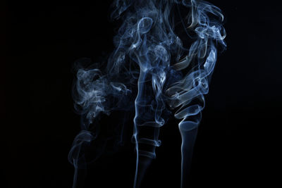 Close-up of smoke emitting from black background