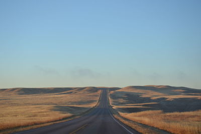 Road amidst landscape against clear sky