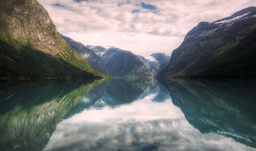 Scenic view of lake and mountains against sky