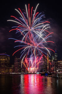 Firework display in city at night