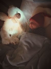 Close-up of baby sleeping on bed at home