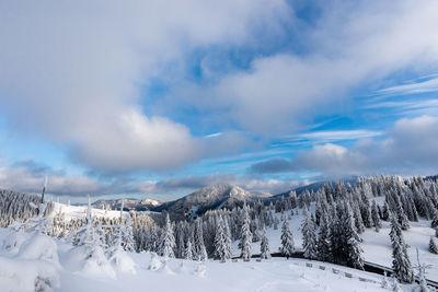 Scenic view of snow covered mountains against sky