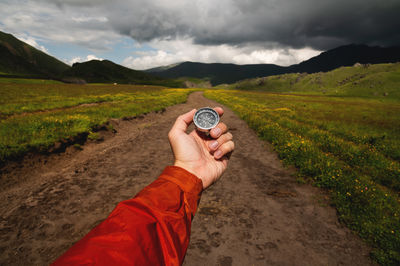 Cropped hand holding navigational compass