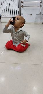 Portrait of girl sitting on floor at home