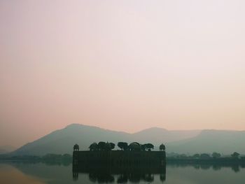 Scenic view of lake against sky during sunset