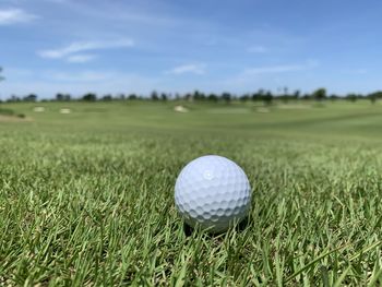 Close-up of ball on field against sky