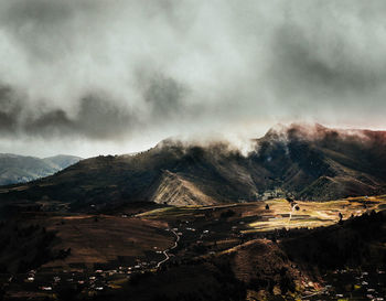 High angle view of land and mountains against sky