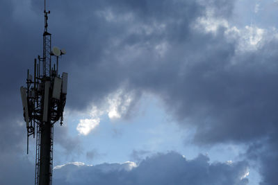 Low angle view of communications tower against sky