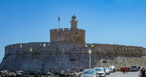 Low angle view of lighthouse against blue sky