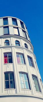 Low angle view of modern building against blue sky