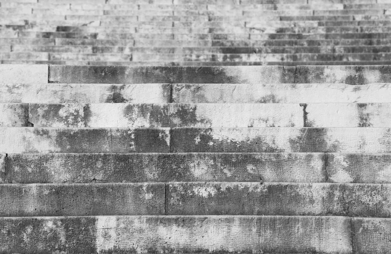 FULL FRAME SHOT OF BRICK WALL WITH BUILDING