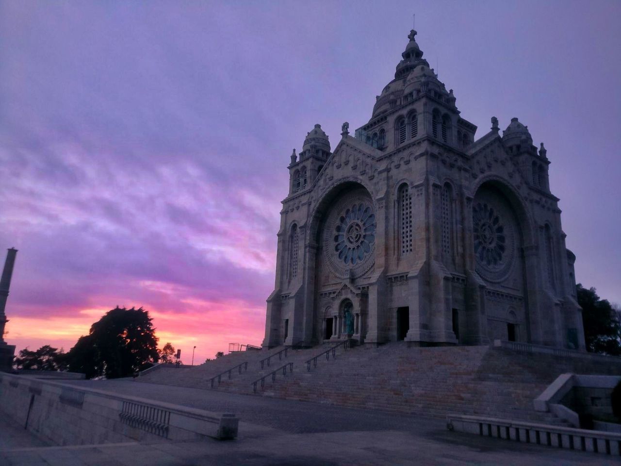 architecture, built structure, sky, religion, spirituality, place of worship, low angle view, building exterior, history, travel destinations, no people, outdoors, sunset, nature, tree, day