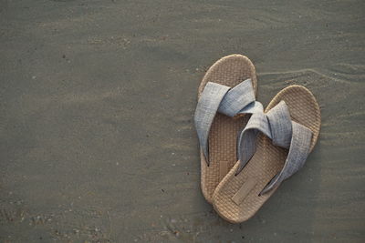 High angle view of shoes on sand at beach