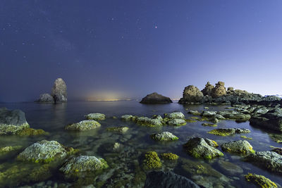 Scenic view of sea against clear sky at night