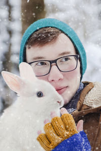 Portrait of young man with rabbit