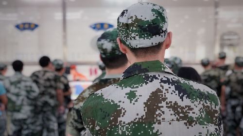 Rear view of men in military uniform