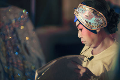 Side view of woman wearing hat