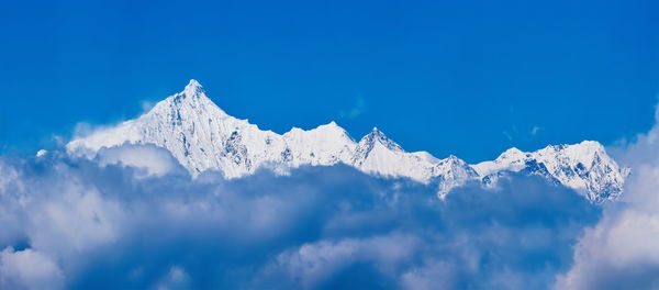 Low angle view of snowcapped mountain against sky