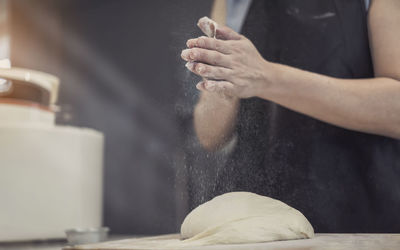 Midsection of man preparing food