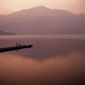 Scenic view of lake at sunset