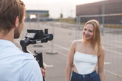 Cameraman is filming the blogger's girl on the street