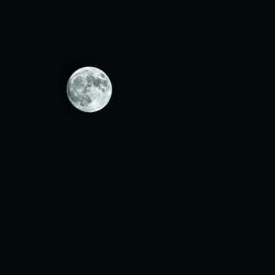 Low angle view of moon against black sky