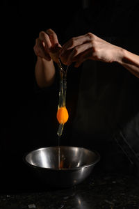 Midsection of person pouring wine in glass