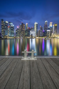 Illuminated buildings against sky at night