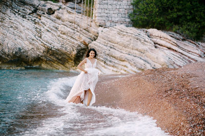 Full length of young woman in water