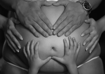 Close-up of hands touching pregnant belly