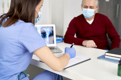 Midsection of woman working at table