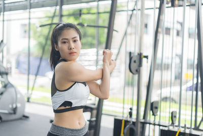 Portrait of young woman exercising at gym