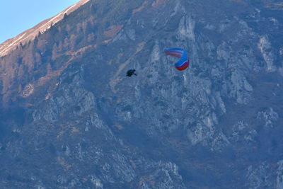People paragliding over mountain
