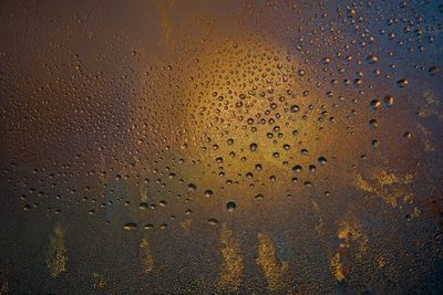 Full frame shot of raindrops on glass window